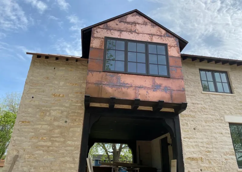 Copper metal panel facade on a stone building for Skylight Installation in Bel Air South